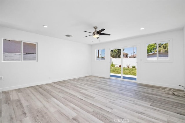 spare room with ceiling fan and light wood-type flooring