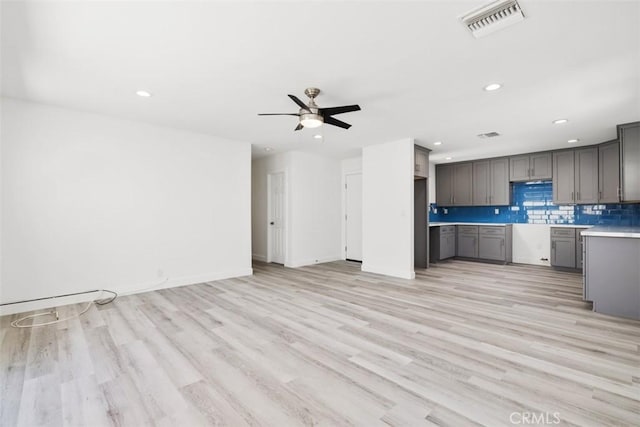 kitchen with light wood-type flooring, gray cabinets, and ceiling fan