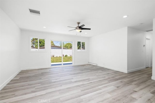 unfurnished room with ceiling fan, a wealth of natural light, and light hardwood / wood-style flooring