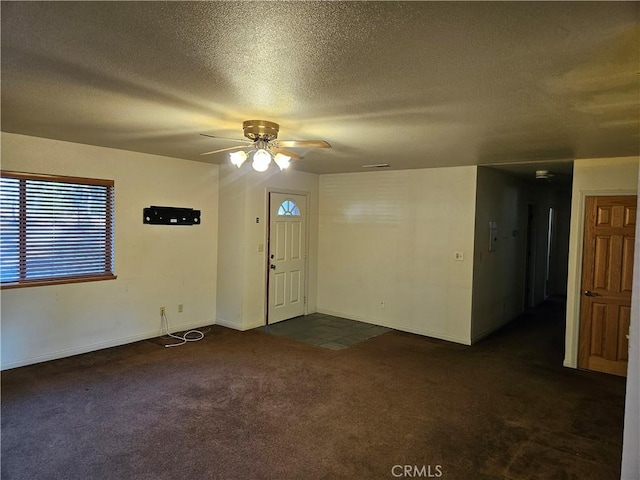 interior space with a textured ceiling and ceiling fan