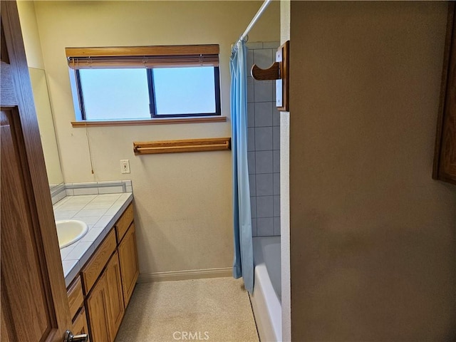 bathroom featuring vanity and shower / bathtub combination with curtain