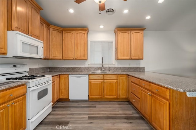 kitchen with white appliances, dark wood-type flooring, sink, ceiling fan, and kitchen peninsula