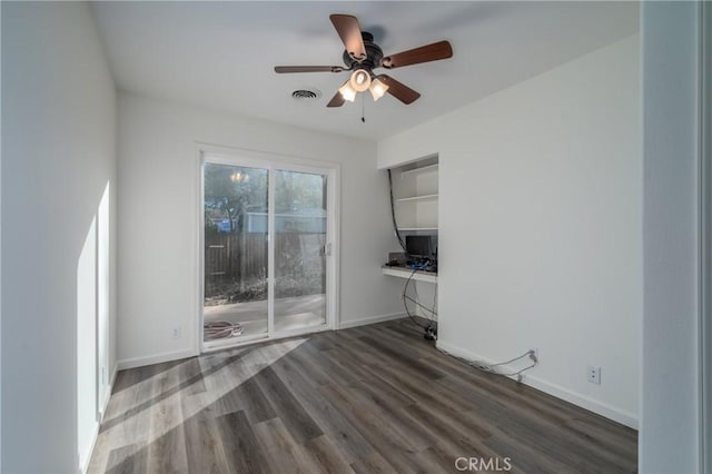 unfurnished room with dark hardwood / wood-style floors and ceiling fan