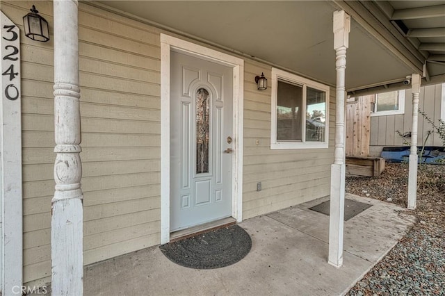 view of exterior entry with a porch