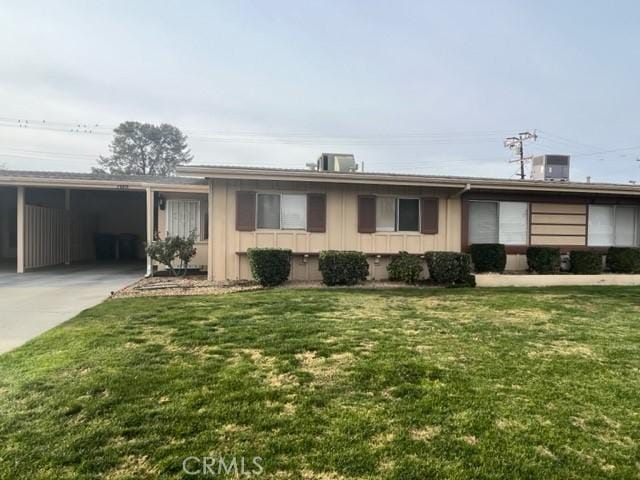 single story home featuring a front yard and a carport