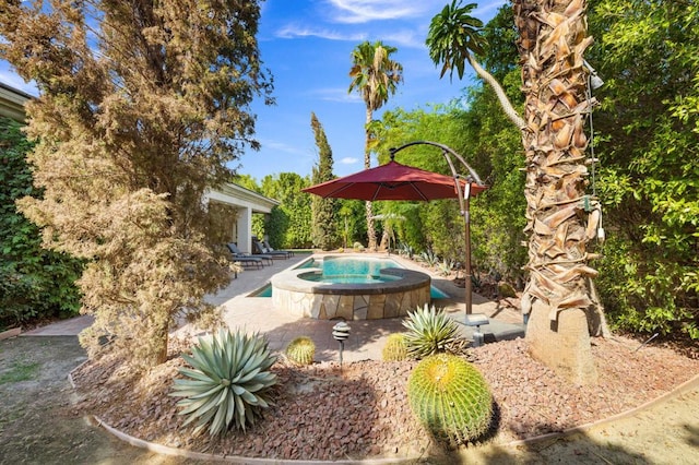 view of pool with an in ground hot tub and a patio area