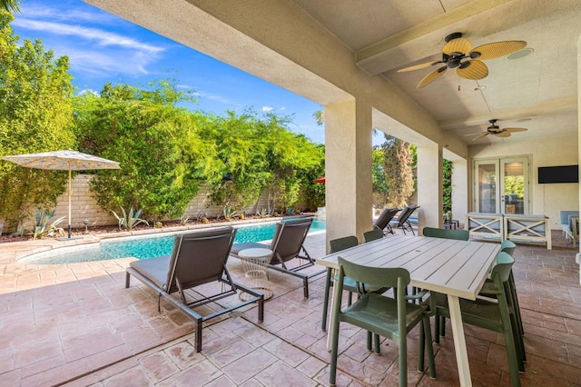 view of patio / terrace featuring ceiling fan and a fenced in pool