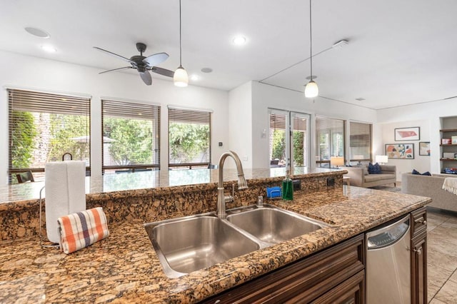 kitchen featuring decorative light fixtures, stainless steel dishwasher, a healthy amount of sunlight, and sink