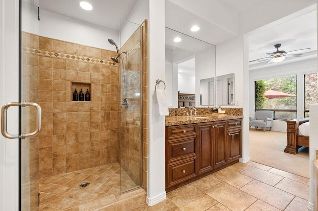 bathroom featuring tile patterned floors, ceiling fan, vanity, and walk in shower