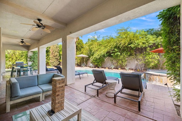 view of patio / terrace with an outdoor living space, ceiling fan, and a fenced in pool