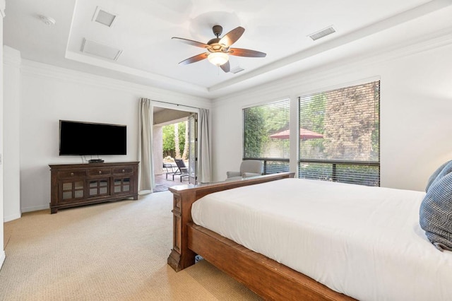 carpeted bedroom with a raised ceiling, ceiling fan, and access to exterior