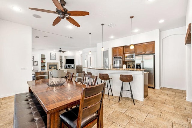 dining space with ceiling fan