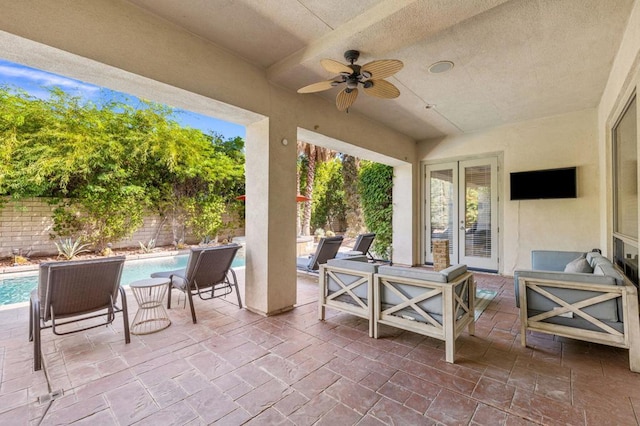 view of patio / terrace featuring a fenced in pool, ceiling fan, and an outdoor hangout area