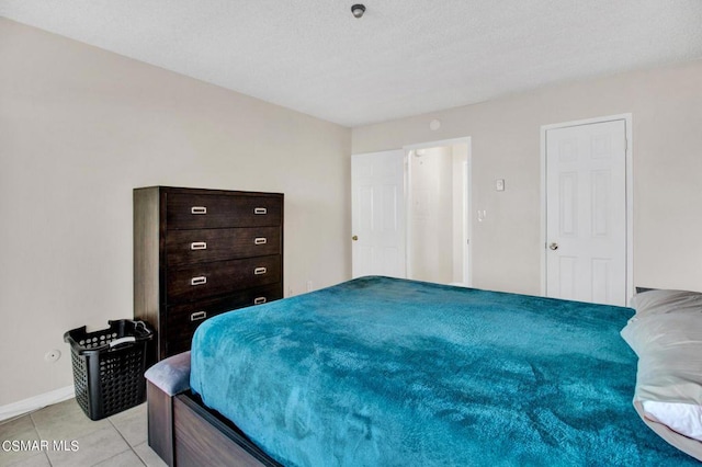 tiled bedroom with a textured ceiling