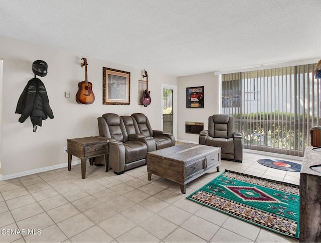 tiled living room featuring a textured ceiling