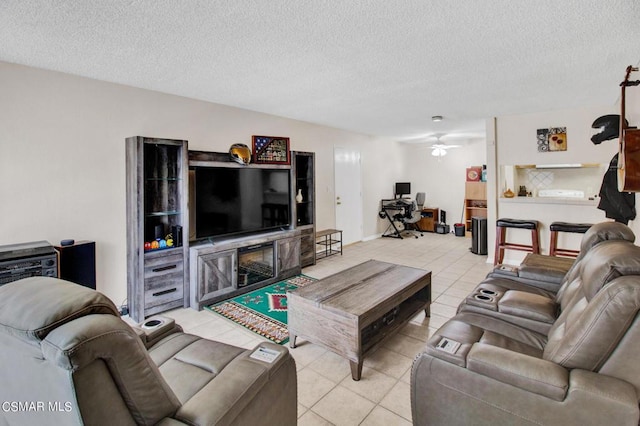 tiled living room with a textured ceiling and ceiling fan