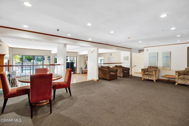 carpeted dining area featuring crown molding