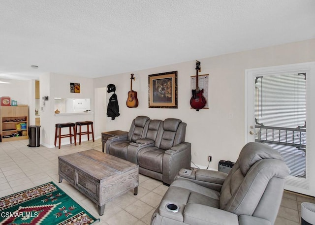 living room featuring light tile patterned floors and a textured ceiling