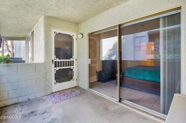 doorway to property featuring a patio and cooling unit