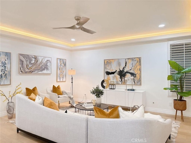 living room with light hardwood / wood-style floors and ceiling fan