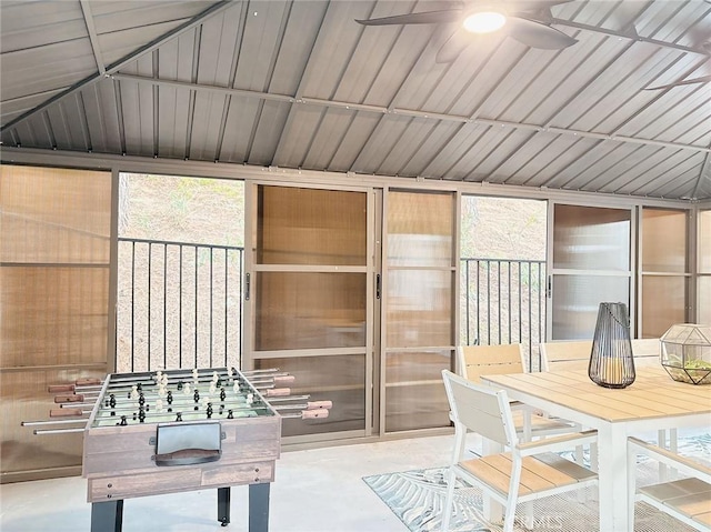 unfurnished sunroom with ceiling fan