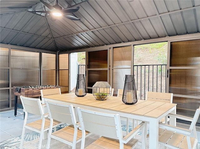 sunroom / solarium featuring a wealth of natural light, lofted ceiling, and ceiling fan