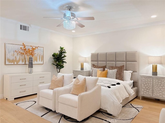 bedroom featuring ceiling fan, light hardwood / wood-style floors, and ornamental molding