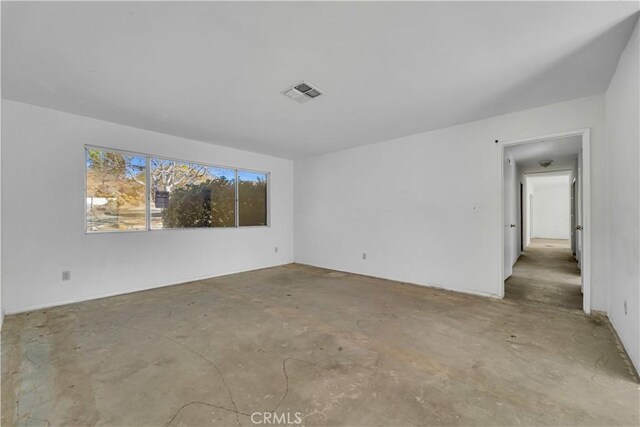 empty room with concrete flooring