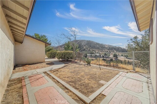 view of yard featuring a mountain view and a patio