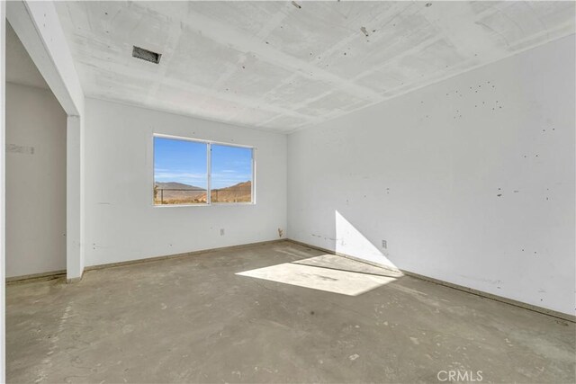 unfurnished bedroom with concrete flooring