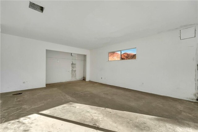 unfurnished bedroom with a closet and concrete flooring