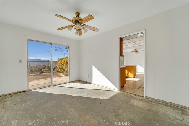 spare room featuring ceiling fan and a mountain view