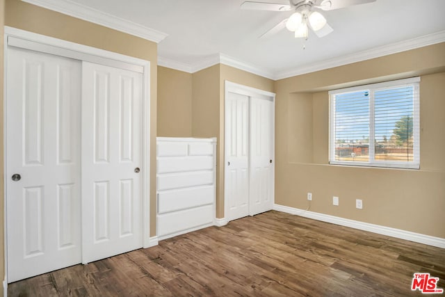 unfurnished bedroom featuring ornamental molding, ceiling fan, and dark wood-type flooring