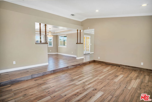 unfurnished living room featuring light wood-type flooring and crown molding