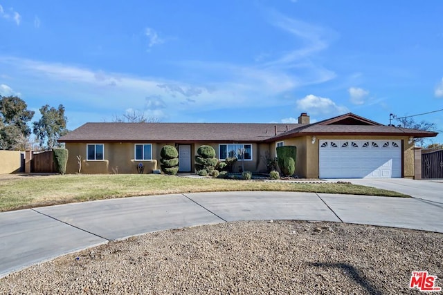 single story home with a garage and a front yard