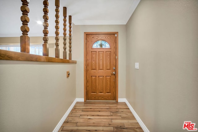 doorway with crown molding and light hardwood / wood-style flooring