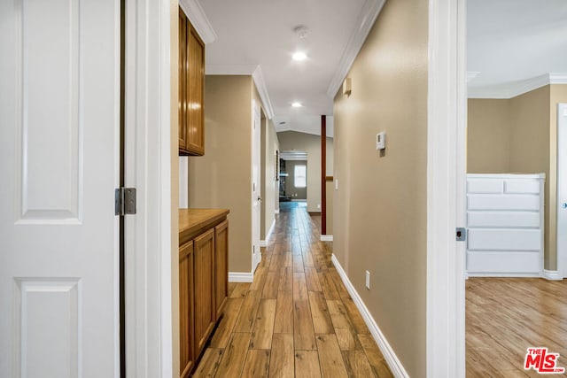 corridor featuring light wood-type flooring and crown molding