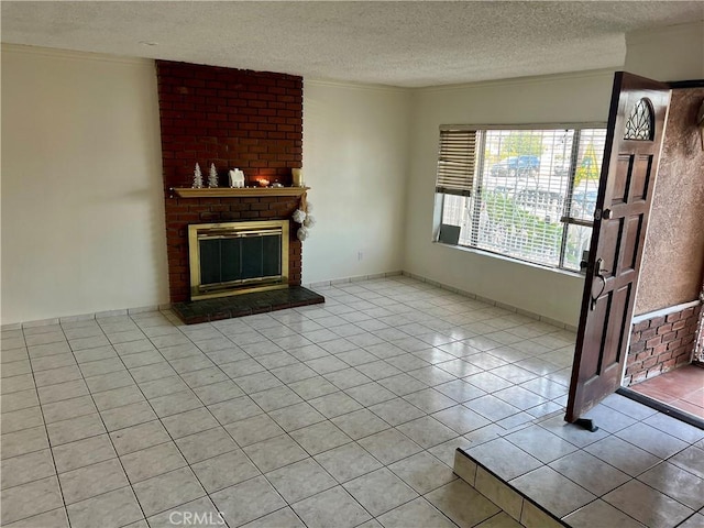 unfurnished living room with light tile patterned flooring, ornamental molding, a textured ceiling, and a brick fireplace