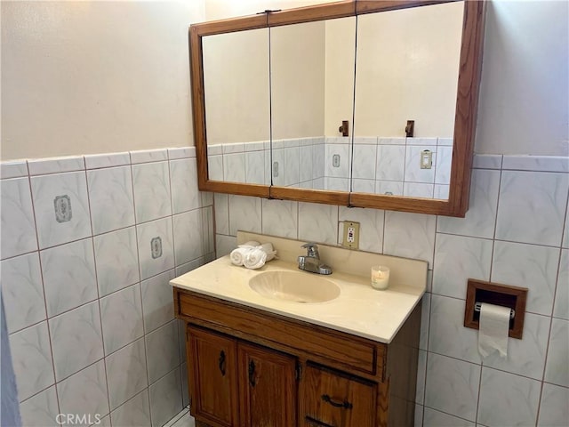 bathroom with vanity and tile walls