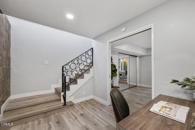 office space featuring recessed lighting, light wood-style flooring, and baseboards