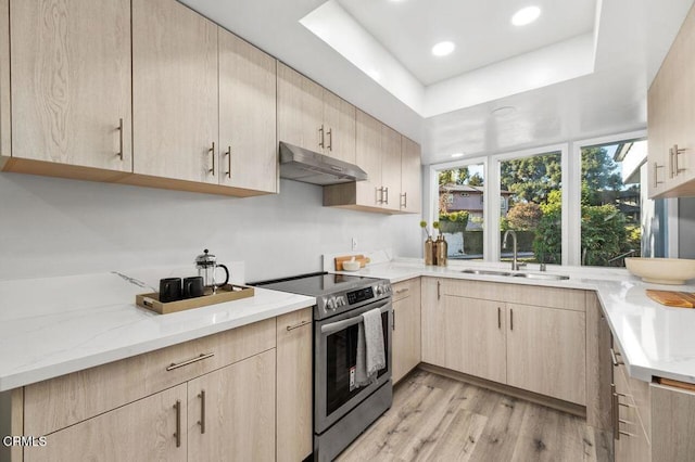 kitchen featuring stainless steel range with electric stovetop, light brown cabinets, and under cabinet range hood