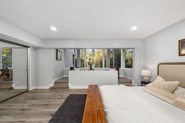 bedroom featuring recessed lighting, wood finished floors, and baseboards