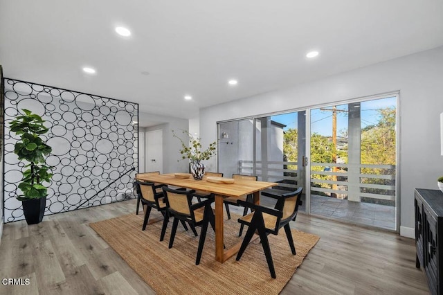 dining space featuring light wood-type flooring and recessed lighting