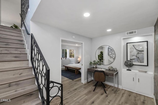 interior space featuring baseboards, wood finished floors, visible vents, and recessed lighting