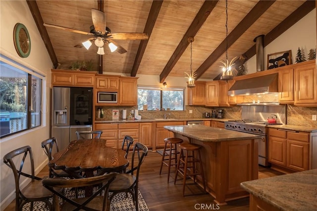 kitchen featuring decorative backsplash, appliances with stainless steel finishes, extractor fan, lofted ceiling with beams, and a center island