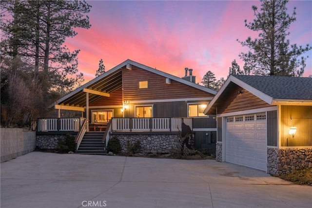 view of front of home featuring a porch and a garage