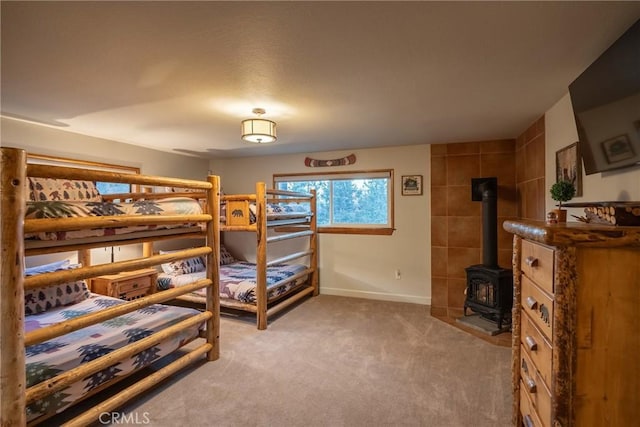 bedroom with light colored carpet and a wood stove