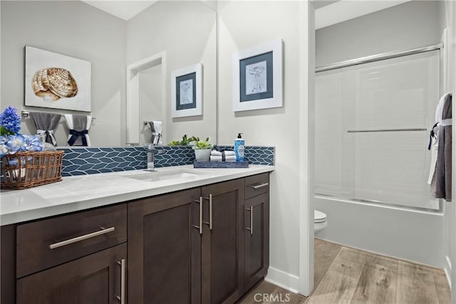 full bathroom with tasteful backsplash, vanity, shower / bathing tub combination, wood-type flooring, and toilet