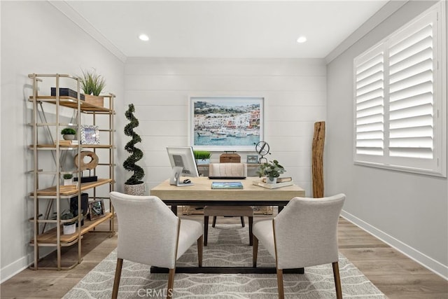 dining area with wood-type flooring and crown molding