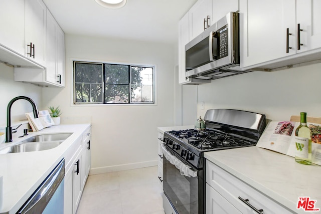 kitchen featuring white cabinetry, sink, and appliances with stainless steel finishes